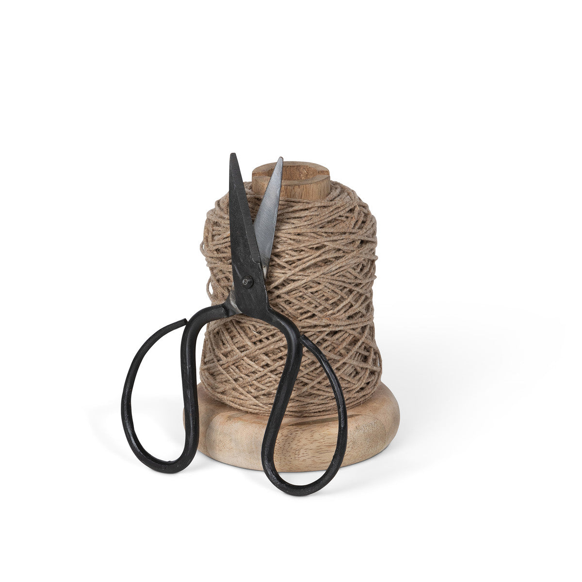 wood spool of jute with black scissors proped on front with white background