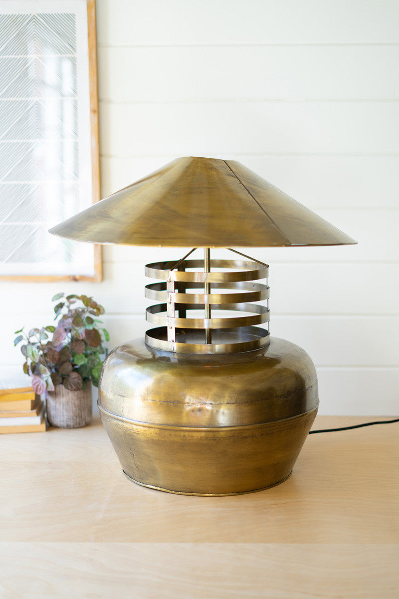 antique brass gold table lamp on a table with plants