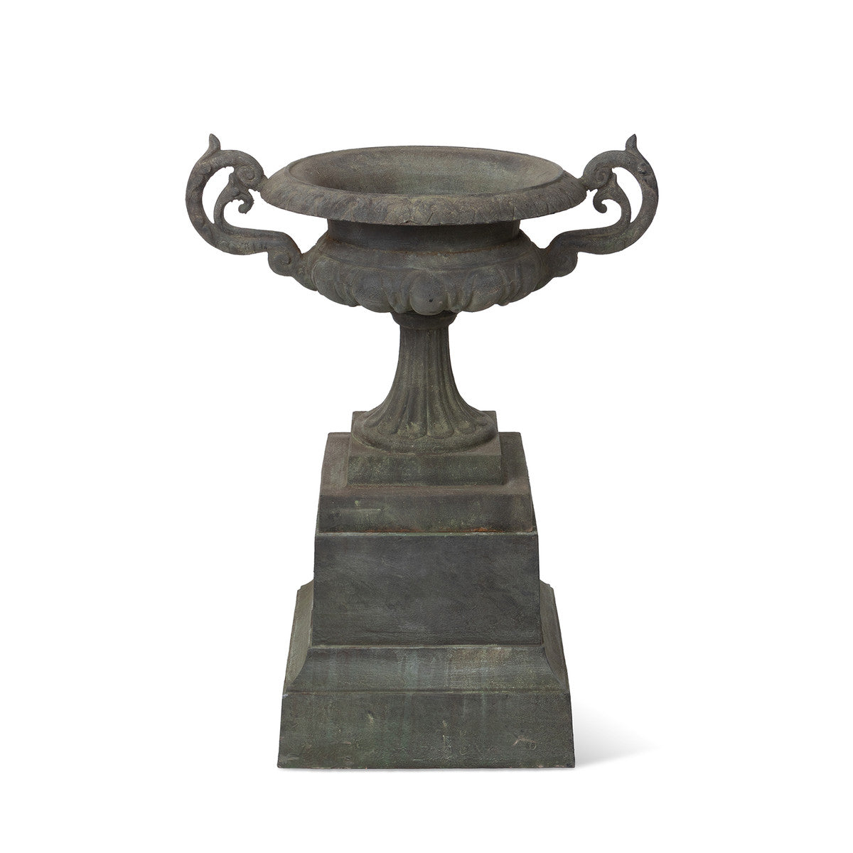 weathered metal urn on pedestal white background