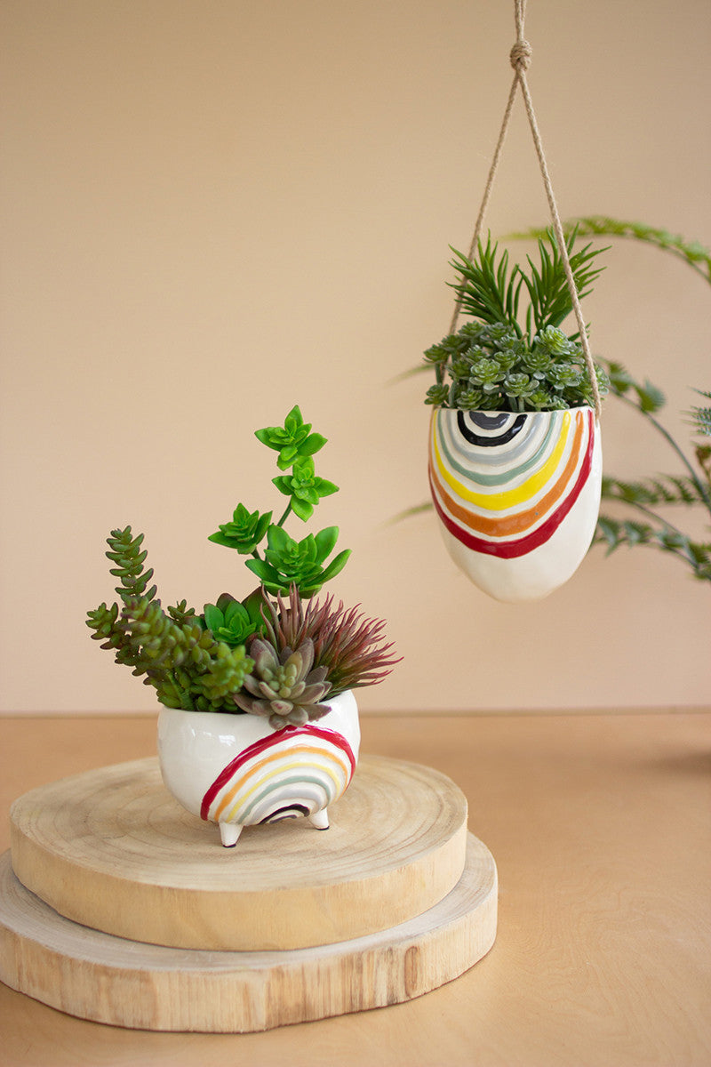 rainbow planters with artificial faux plants inside on wood risers