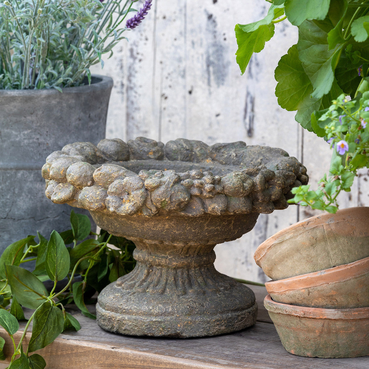 antique italian  Renaissance style garden bowl  on a bench in the garden
