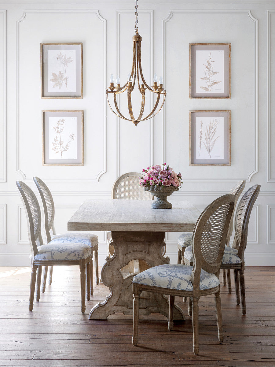 Empress-iron-distressed-white-Chandelier-light-fixture-with  farm table and vase of pink flowers