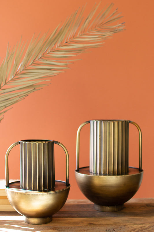two empty metal antique gold finished vases  with orange wall