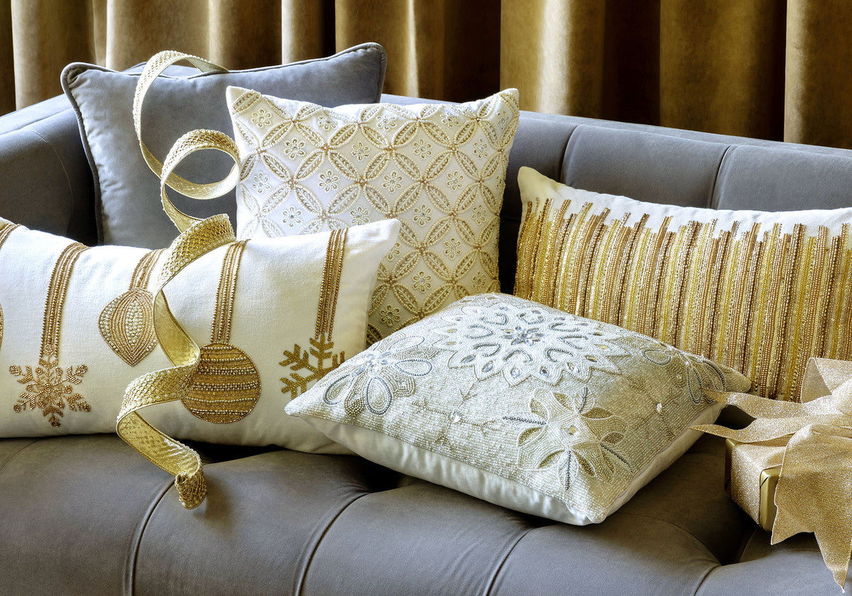 five luxe throw pillows on grey couch 