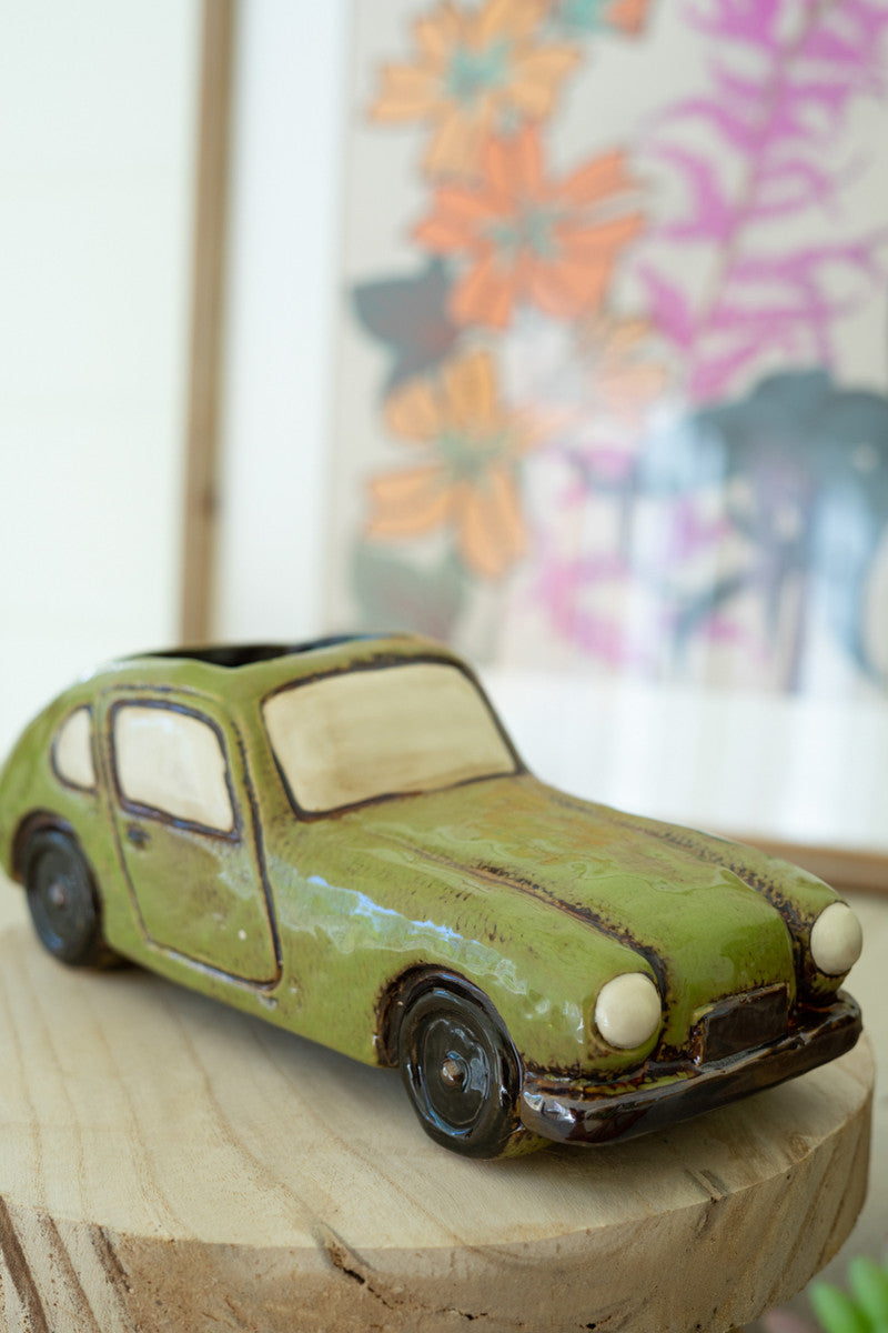 a small green retro car planter 