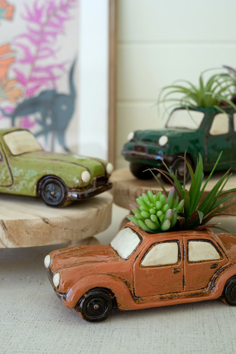 three car planters with faux plants