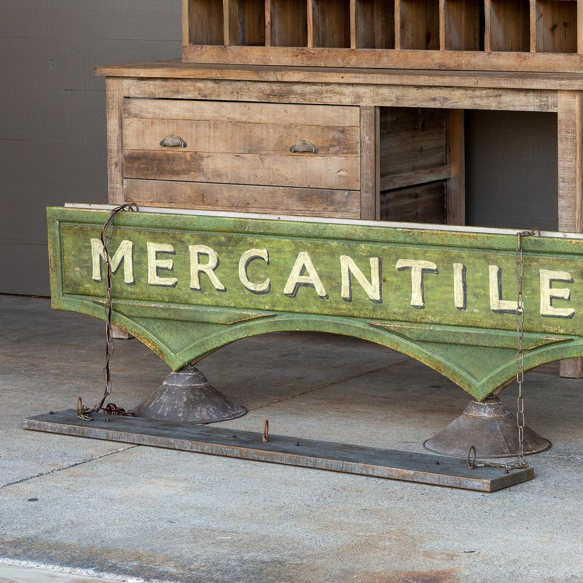 green mercantile sign in front of wood desk