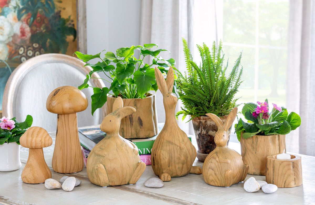 tablescape with wood bunnies and mushrooms plus green real and faux plants