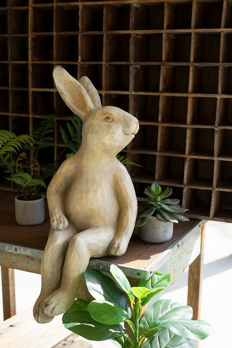 faux concrete bunny rabbit decor with green succulent plants on table 