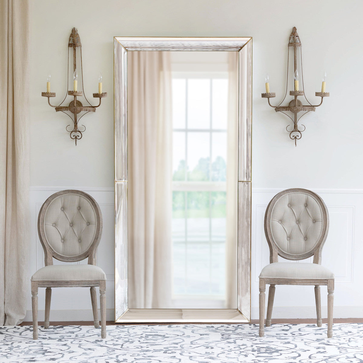 floor mirror elegant sconces chairs and rug