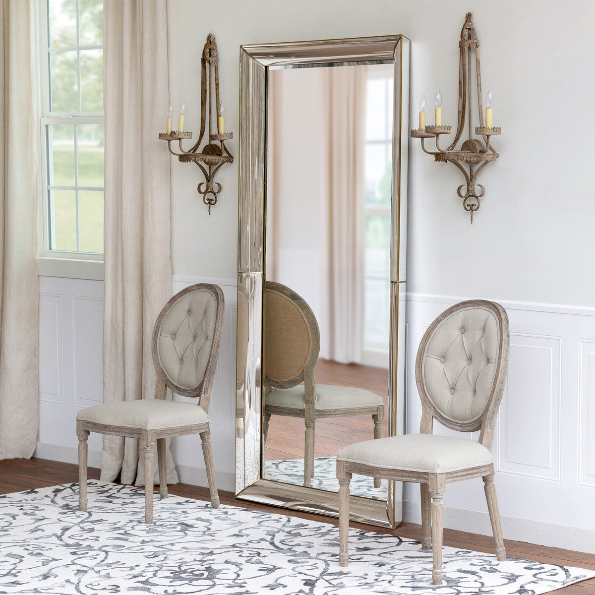 luxe floor mirror sconces two chairs rug