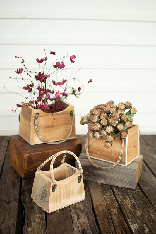three wood pocket book purse planters with flowers in them