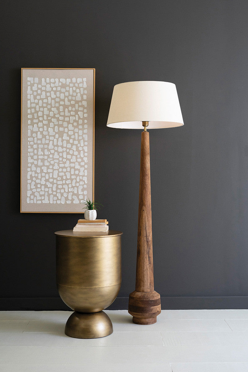 unique shaped tall wood lamp stand with fabric shade styled with a modern art print and brass side table and succulent plant
