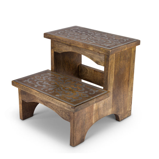 wood step stool with ornate metal inlay luxe furniture piece white background
