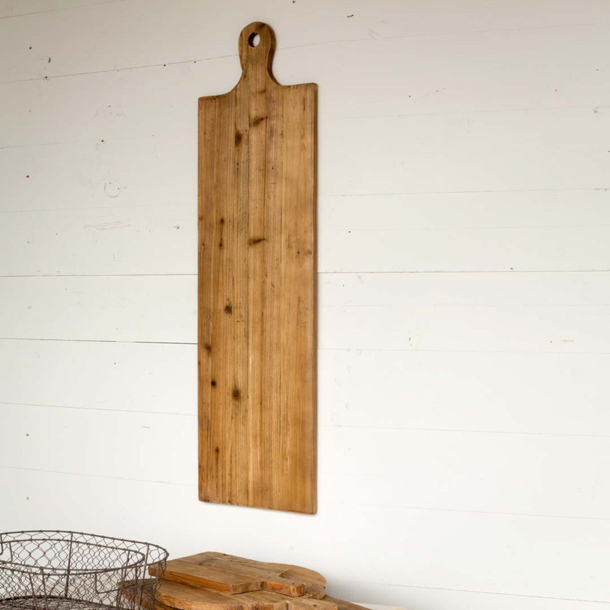 french charcuterie bread board hanging on a white wall 