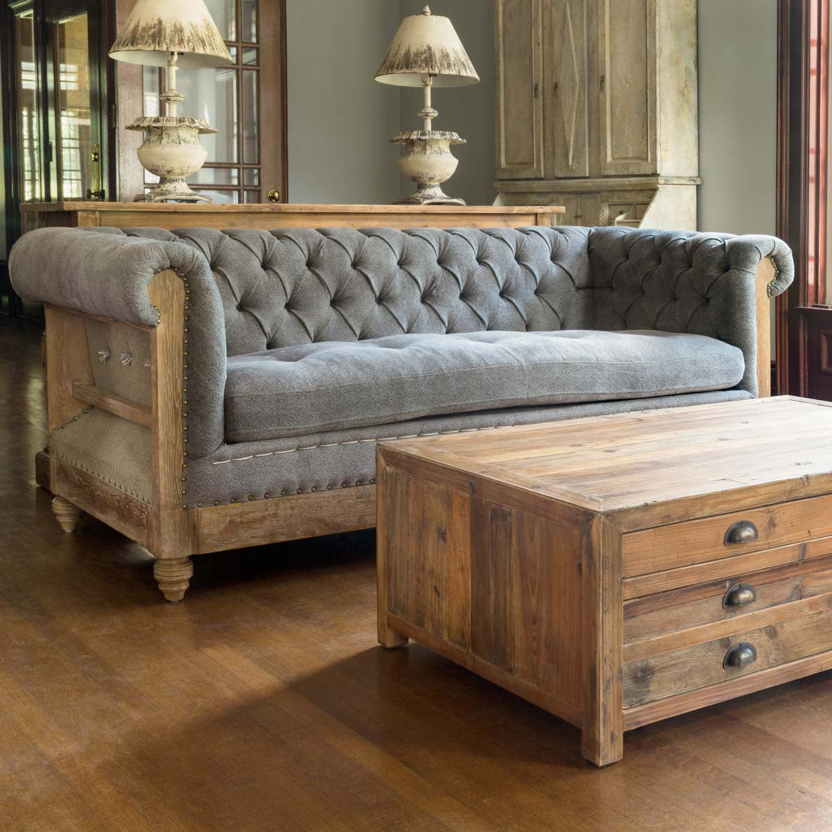 tufted grey stately sofa with coffee table