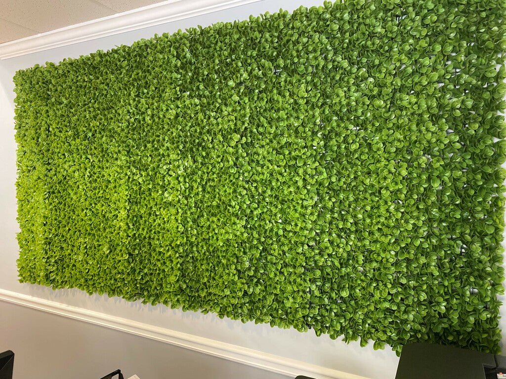 faux artificial green jade leaf roll on a wall