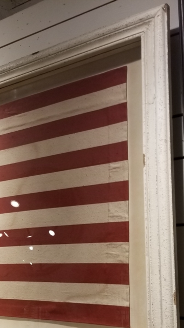 framed american flag under glass detail shot
