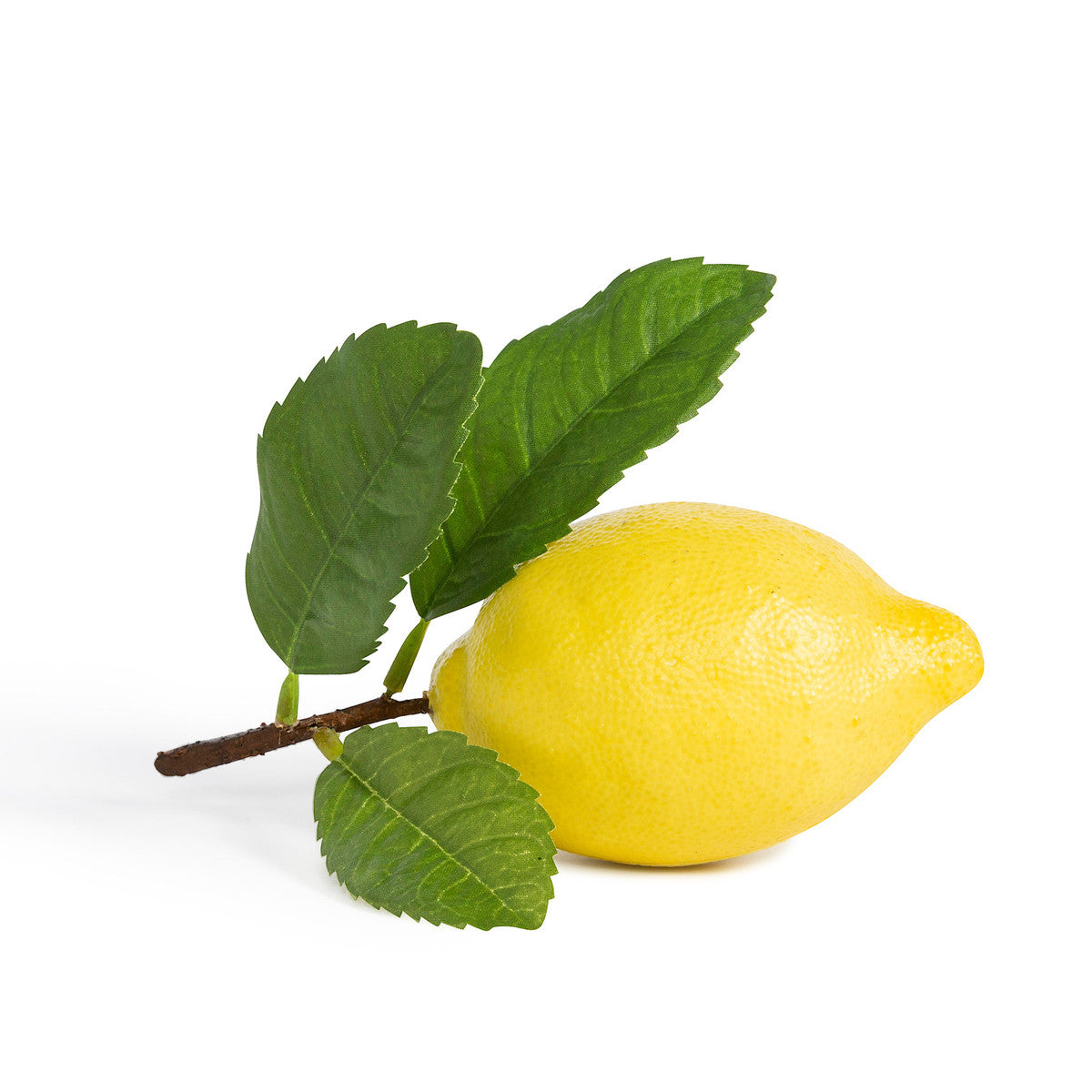 faux yellow artificial lemon with green leaf on white background