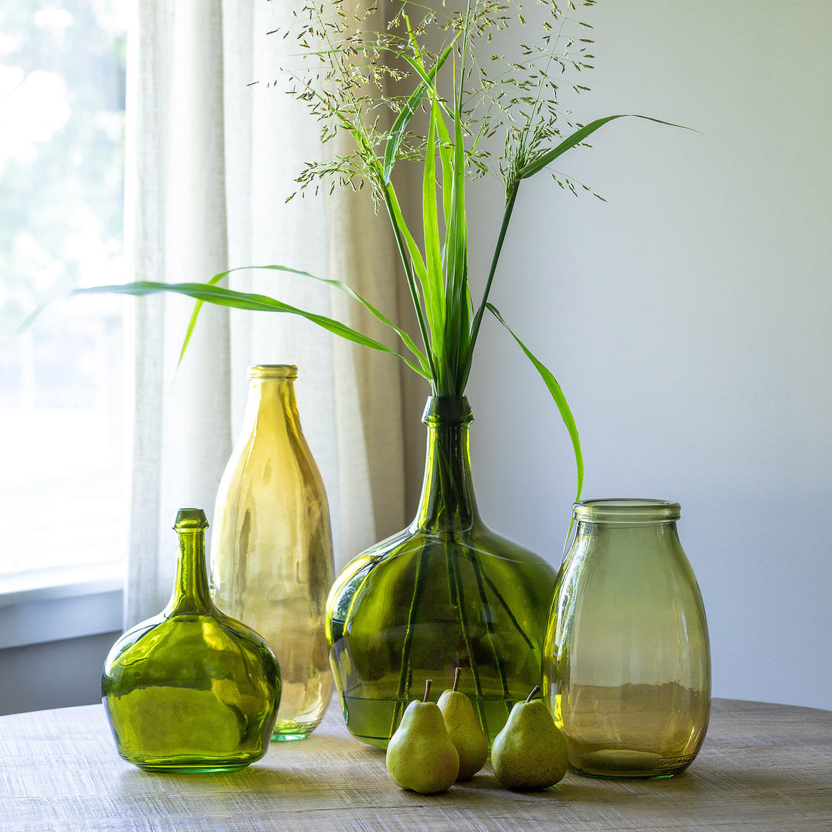 green vase and gold vase collection with pears and grass