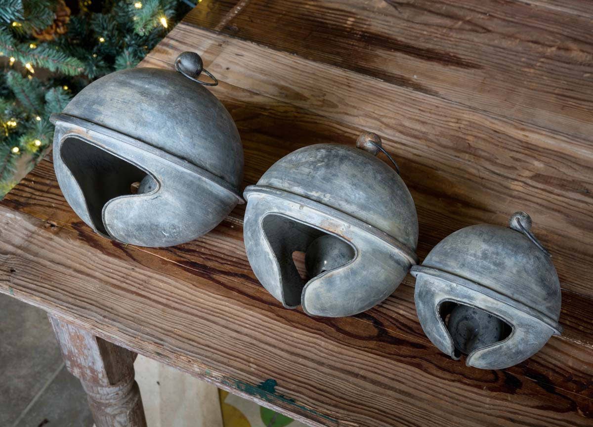 set-of-3-oversized-metal-christmas-holiday-bells-on-wood-table