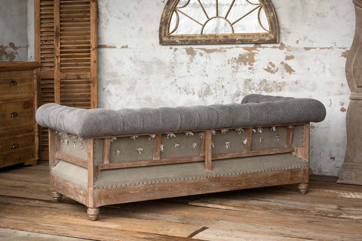 back-side-of-tufted-couch-on-hard-wood-floors