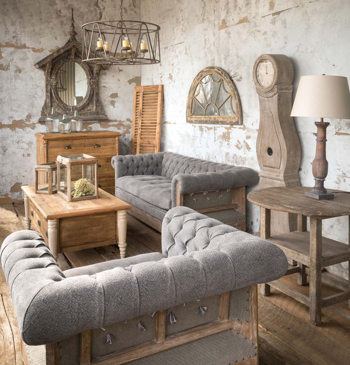 tufted-gray-sofa-chair-with-coffee-table-clock-lamp-and-mirror