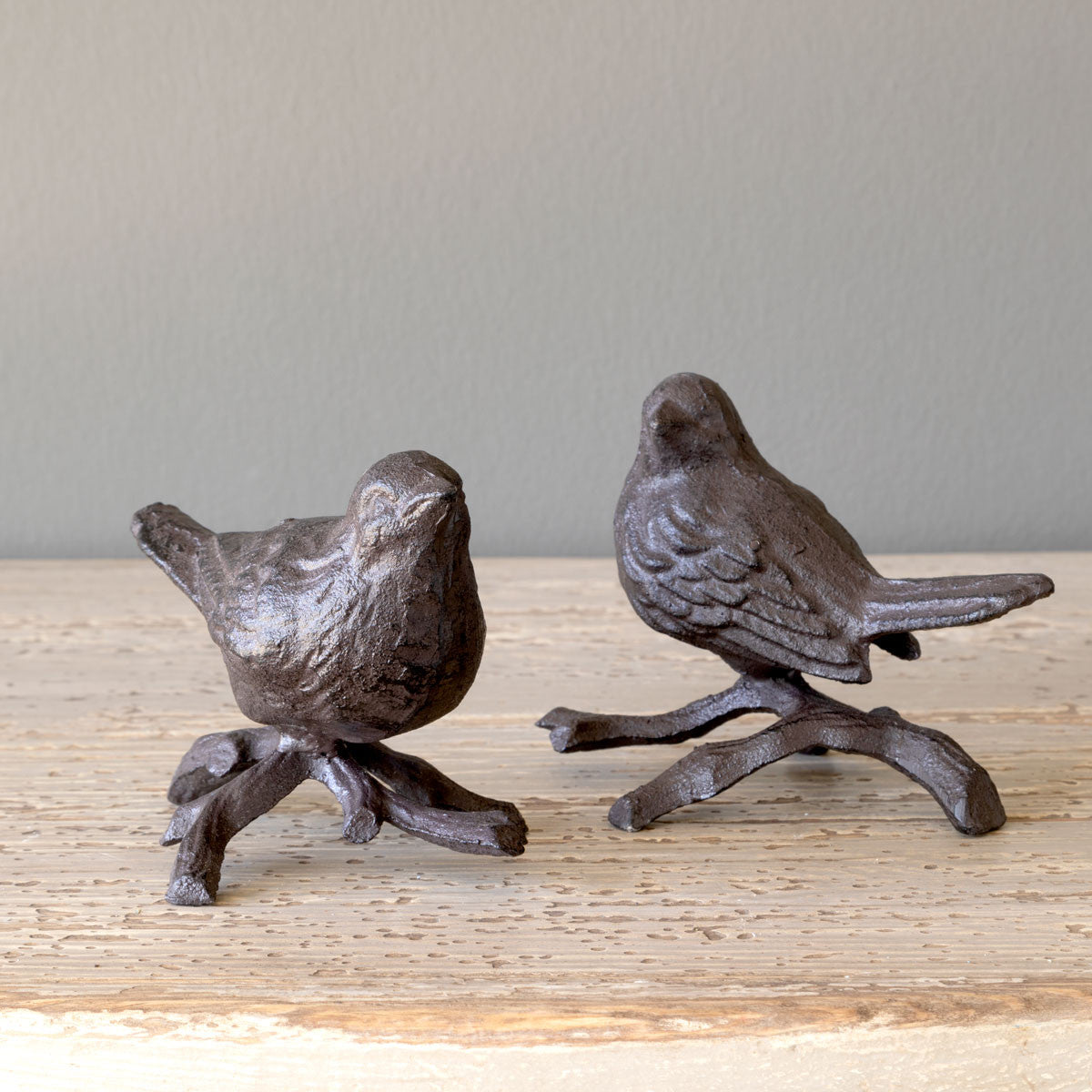 perched iron bird nature decor on wood table