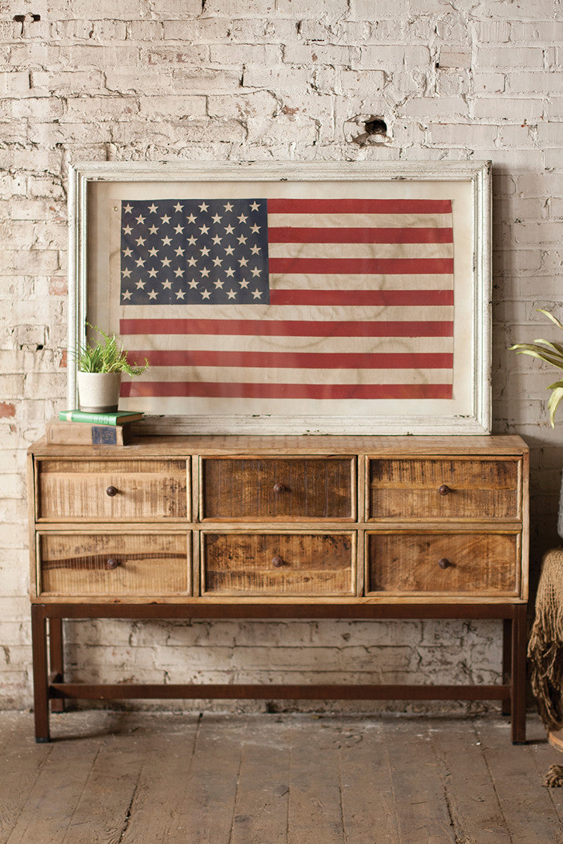 framed american flag on  a brick wall