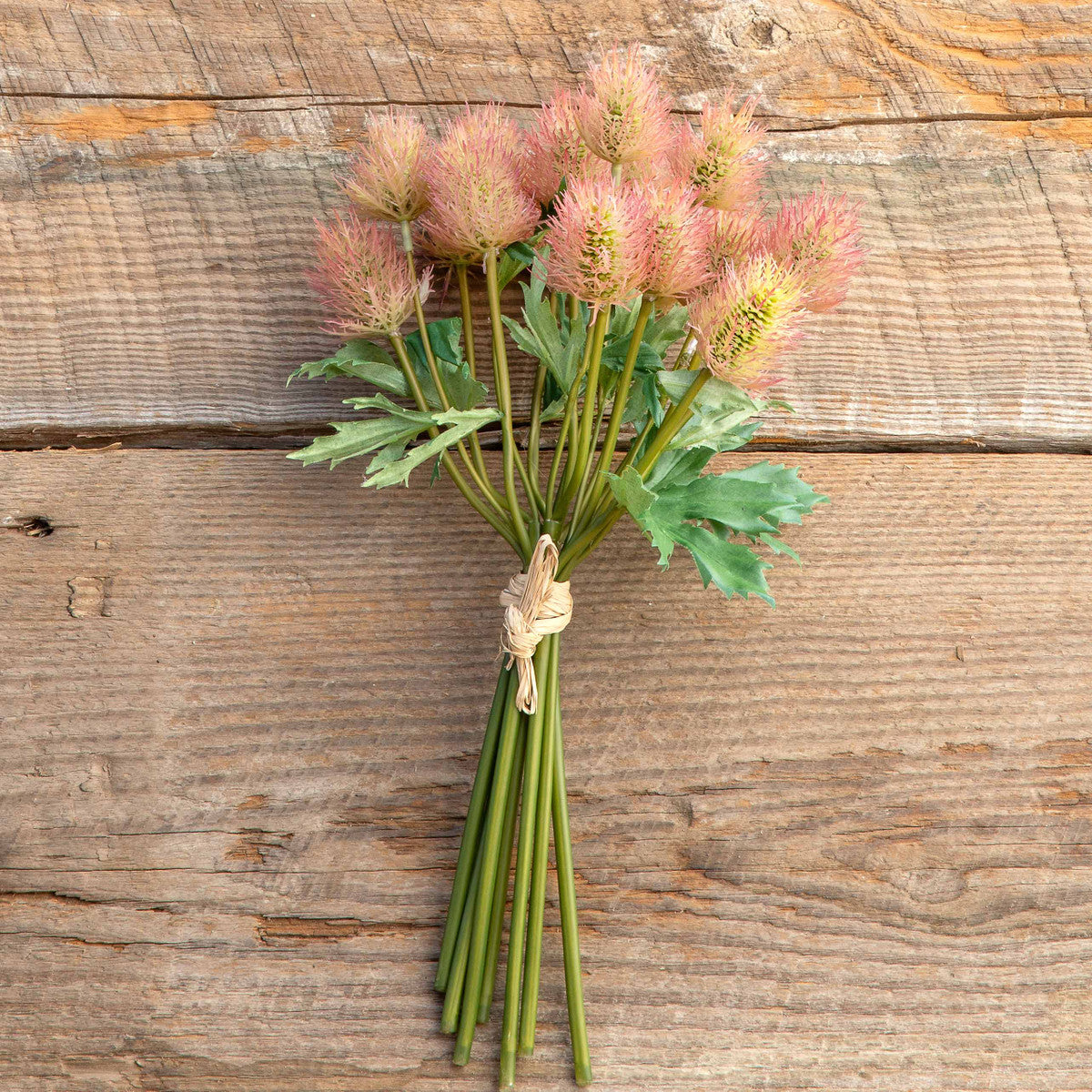 artificial-faux-bunch-of-thistle-stems-on-wood-table
