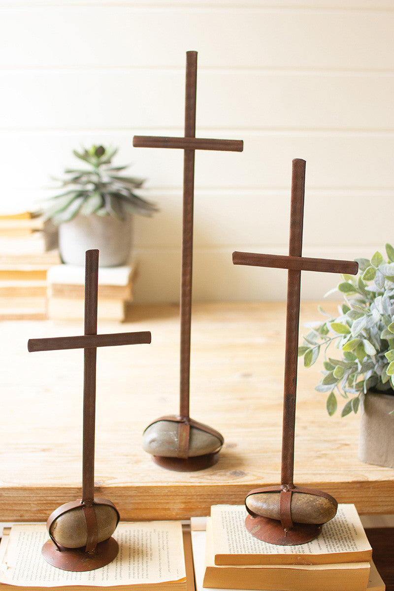 relgious crosses on a desk with succulent