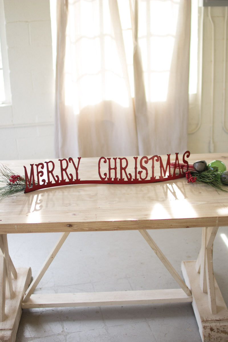 red merry christmas sign styled on table 
